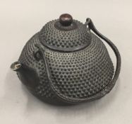 A cast metal teapot