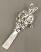 A silver cat rattle