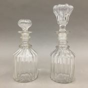 Two small glass three ringed decanters and stoppers,
