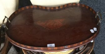 A 19th century mahogany inlaid kidney shaped tray with brass side handles