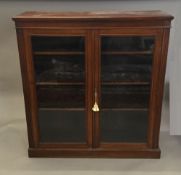 A Victorian glazed walnut floor standing bookcase