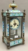 A cloisonne decorated four glass clock,