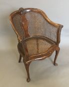 An early 20th century bergere armchair