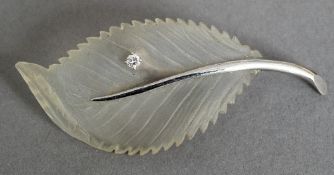 A 14 ct white gold diamond set brooch, formed as a leaf. 15.