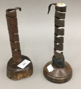 Two 18th century walnut based iron spiral candlesticks of typical form