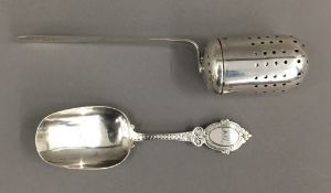 A silver infuser and a silver caddy spoon