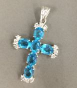 A silver and cubic zirconia cross pendant