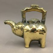 An Eastern bronze teapot formed as an elephant