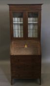 An early 20th century oak bureau bookcase