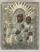A white metal clad painted icon