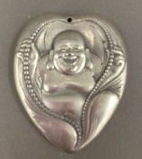 A heart shaped pendant decorated with Buddha