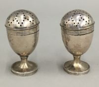 A pair of Victorian silver pepper pots