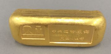 A gilt paperweight/bar