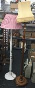 A early 20th century oak standard lamp and a white painted standard lamp