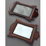 A George III mahogany framed wall glass With scroll carved border,