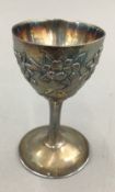 A Chinese export silver egg cup, the double skin bowl worked with floral sprays,