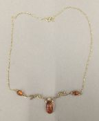 A 9 ct gold and amber necklace (5.