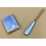 An enamel decorated matchbox case and a pair of enamel decorated tweezers