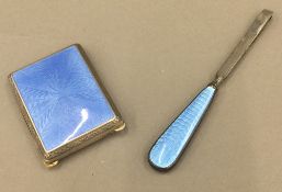 An enamel decorated matchbox case and a pair of enamel decorated tweezers