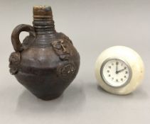 A 1920s alabaster clock and a Studio Pottery bellarmine