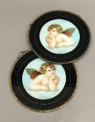 A pair of 19th century brass mounted roundels decorated with cherubs