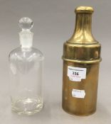A travelling glass decanter and stopper in brass sleeve and cover