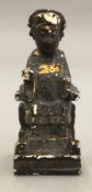 An antique Chinese carved wood painted tomb type figure, worked as a seated dignitary,