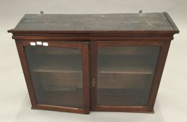 A 19th century mahogany glazed hanging cabinet