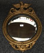 A convex mirror surmounted with an eagle,