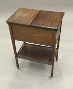 An early 20th century mahogany sewing table