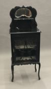 An ebonised side cabinet