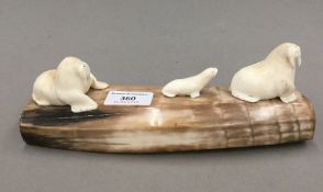 Three carved whales tooth walruses