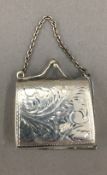 A small chased silver purse