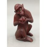 A Japanese carved wooden monkey