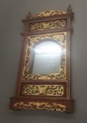 A Chinese carved wood wall glass