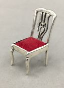 A miniature silver chair