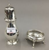 A silver sugar castor, Chester hallmarks and a table salt on four hoof legs,