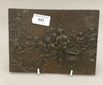 A bronze plaque depicting a tavern interior