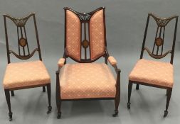 A late Victorian inlaid armchair and a pair of matching side chairs