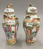A pair of small 19th century Canton lidded vases