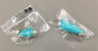 Two silver and turquoise pendants