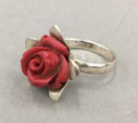 A silver and coral ring