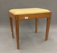 A satinwood upholstered stool in the Sheraton style