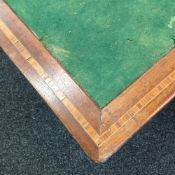 An inlaid mahogany folding card table