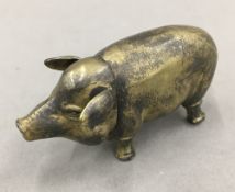 A brass pig vesta