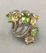 A silver peridot and citrine ring