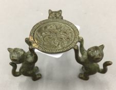 A bronze model of cats