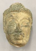 An antique pottery Buddha head and later stand