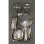 A silver dressing table set with a plated tray