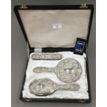 A cased silver dressing table set